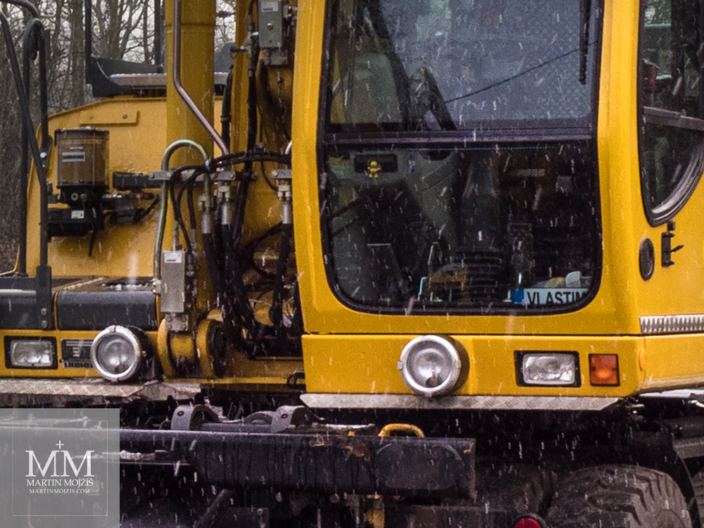 The excavator cabin, falling snow. Photograph created with the Olympus 12 - 40 mm 2.8 Pro lens.